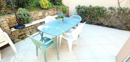une table et des chaises bleues sur une terrasse dans l'établissement Island of calm with sea view, à Saint-Tropez