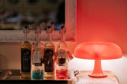 a group of bottles on a table next to a lamp at Manfredi ristorante con alloggio in Romentino