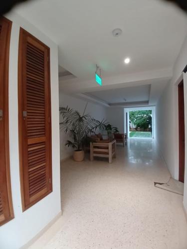 a room with a hallway with a door and a table at Sandbox Apartment 4 Diani Beach Kenya in Ukunda