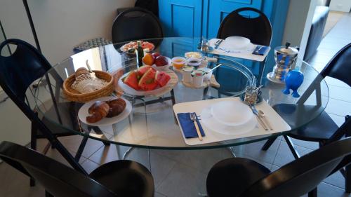 a glass table with a plate of food on it at B&B Il Vicolo Di Pizzo in Pizzo