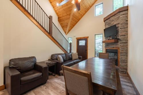 a living room with a dining room table and a fireplace at 3BR Walk-In Near Silver Dollar City - Game Room - Pool - FREE TICKETS INCLUDED - RR93A in Branson