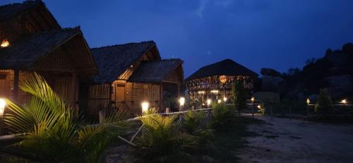 a resort building with lights at night at Hill Stone View Hampi in Hampi