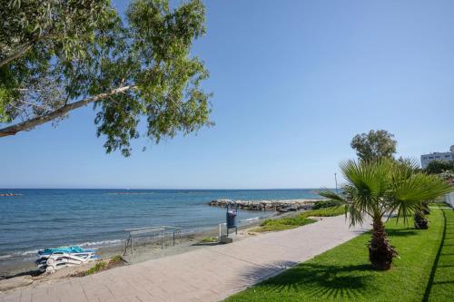 a walkway next to the water with a beach at Hallmark Beach by TrulyCyprus in Limassol