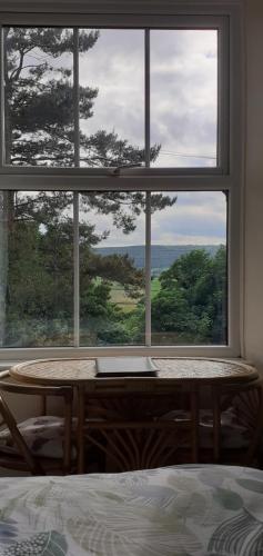 a room with a window with a table and a laptop at Plumtree House in Brigsteer