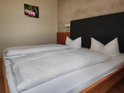 a bedroom with two beds with white sheets at Gasthof Zahler in Röfingen