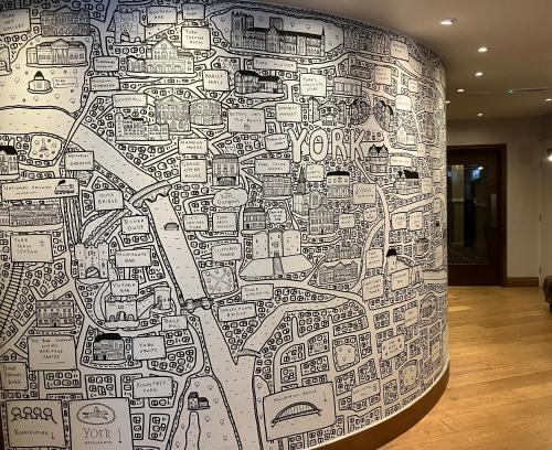 un muro con molti adesivi sopra di Hotel Indigo York, an IHG Hotel a York