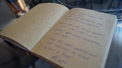 an open book with handwriting on the pages at B&B Il Vicolo Di Pizzo in Pizzo