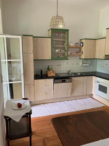 a kitchen with wooden cabinets and a table with a plate on it at Louisenvilla in Bad Gleichenberg