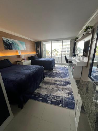 a hotel room with a bed and a sink at Ocean Manor Tiki Sunset Retreat in Fort Lauderdale