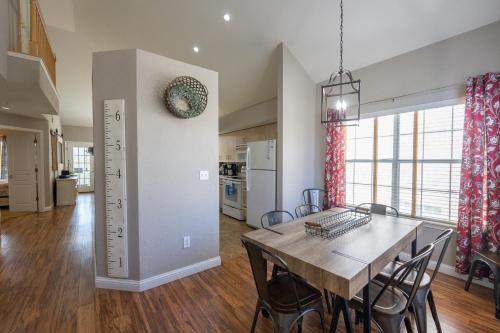 a dining room and kitchen with a table and chairs at 3BR with Loft - Near The Strip - FREE TICKETS INCLUDED - FW2-6 in Branson