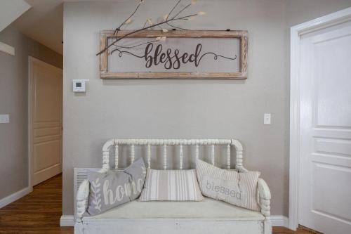a white bench in a room with a sign on the wall at 3BR with Loft - Near The Strip - FREE TICKETS INCLUDED - FW2-6 in Branson