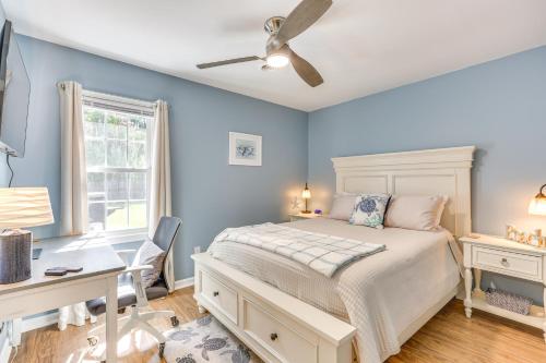 a bedroom with blue walls and a bed and a desk at Wilmington Family Home 6 Mi to Wrightsville Beach in Wilmington