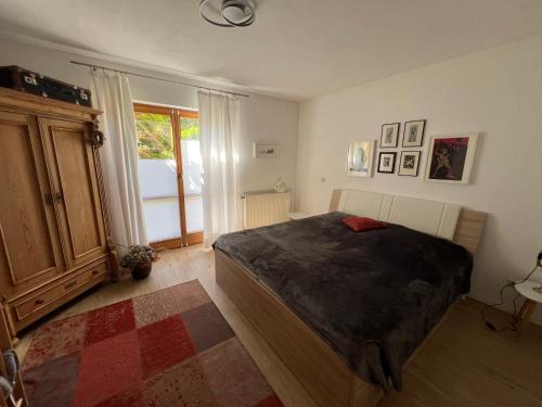 a bedroom with a bed and a large window at Ferienwohnung Am Kiessee Birkwitz in Pirna