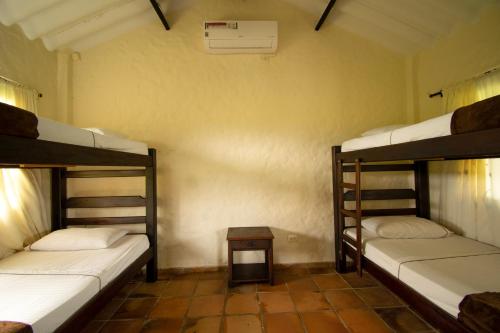 a room with three bunk beds and a table at Tiuma Park in Marsella