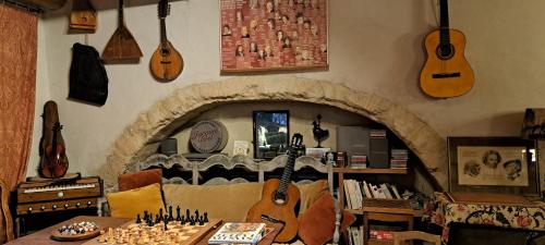 a living room with guitars hanging on the wall at Le Mas du Lac in Uzès