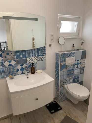a bathroom with a sink and a toilet at Villa hygge in Šibenik