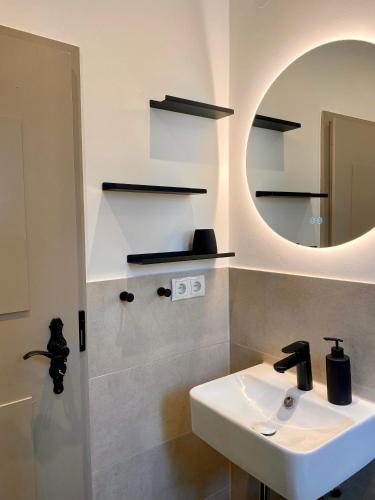 a bathroom with a sink and a mirror at Das Winzereck - 4 Sterne Ferienhaus in der Südpfalz in Ranschbach