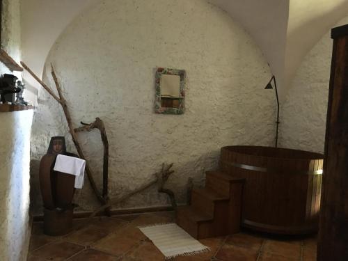 a bathroom with a wooden tub and a sink at Holubník statečných žen králových in Luže