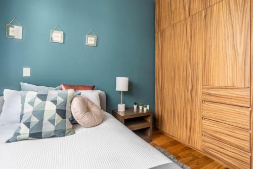 a bedroom with a bed and a wooden cabinet at New PH for 6, BBQ and amazing private roof terrace in Mexico City