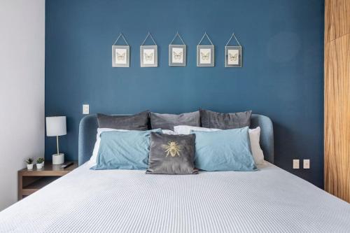 a blue bedroom with a bed with blue walls at New PH for 6, BBQ and amazing private roof terrace in Mexico City