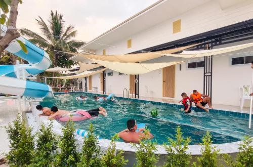 a group of people in the swimming pool at a resort at 189Premier Villa Lamphun in Lamphun