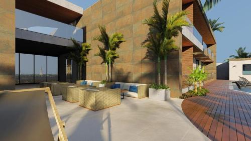 een patio met stoelen en palmbomen op een gebouw bij Marino Beach Hotel in Cabo Frio