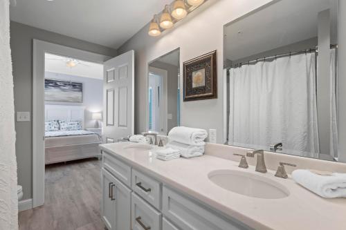 a bathroom with a sink and a large mirror at Perdido Dunes Tower 3E in Orange Beach