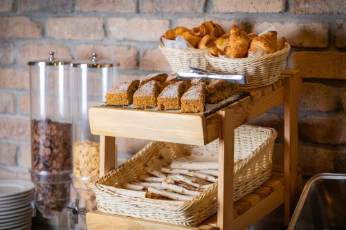 a table topped with baskets of bread and pastries at DiliJazz Hotel & Restaurant in Dilijan