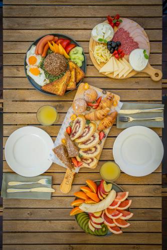 a wooden table with plates of food on it at DiliJazz Hotel & Restaurant in Dilijan