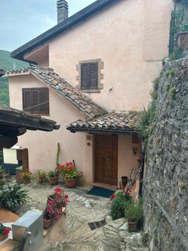 a house with a door and a stone wall at Casa Belvedere a Valle San Martino di Spoleto in Spoleto