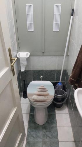 a small bathroom with a toilet with towels on it at MIDI ROOM terrace wifi carparking in Siófok