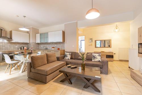 a living room with a couch and a table at FoRest & sea view apartment in Argostoli