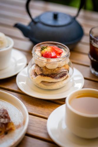 a table with plates of food and cups of coffee at DiliJazz Hotel & Restaurant in Dilijan
