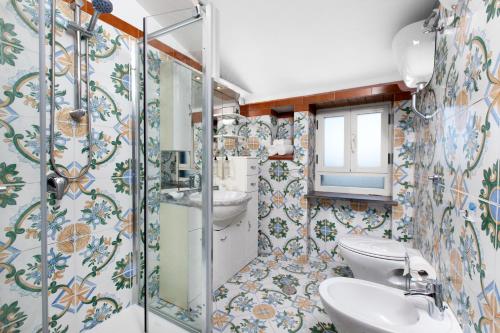 a bathroom with a toilet and a sink at YourHome - Jolly Pini Apartment in Sant'Agnello