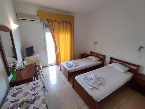Postel nebo postele na pokoji v ubytování Estelle Hotel