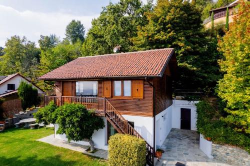 a house with a deck and a yard at Chalet Sophie - Luxury Chalet in Roletto