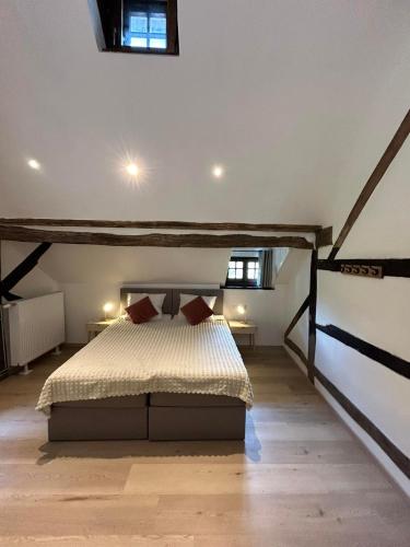 a bedroom with a bed in a attic at Au vieux nid, circuit de spa Francorchamps in Stavelot