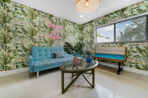 a living room with a blue couch and a table at Westchester Garden in Miami