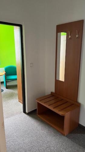 a dressing room with a mirror and a bench at Grandhotel Nový Bor in Nový Bor