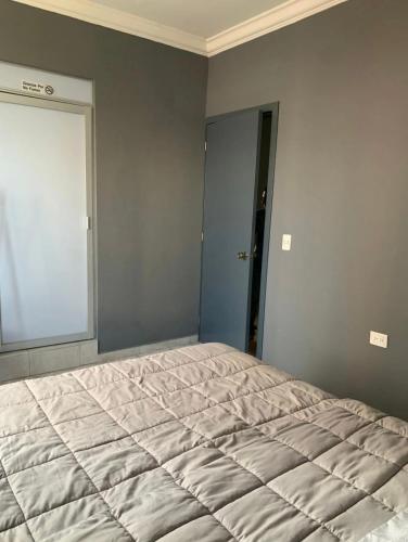 a bedroom with a large bed in the corner at Front Vista in Aguascalientes