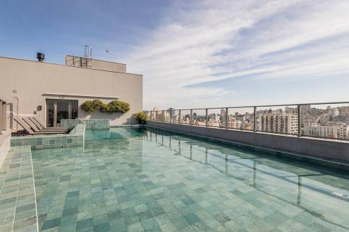 a swimming pool on the roof of a building at Loft Moderno novo JPRE718 in Porto Alegre