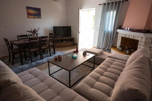 a living room with a couch and a table at Τα ανετα διαμμερισματα του Λεκα in Zakharo