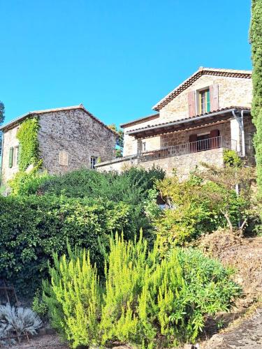an old stone house with plants in front of it at La Magnanerie du Berguier in Laurac-en-Vivarais