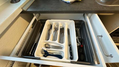 a drawer in a kitchen with utensils in it at MiCasa TuСasa - 2-R-Apartment Leipziger Neuseenland Hydra in Borna