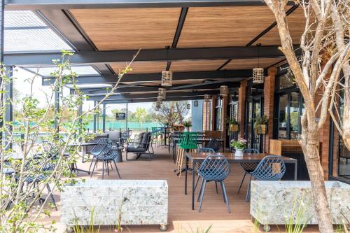 an outdoor patio with tables and chairs and tablesktop at The Lagoon Exquisite Apartments in Pretoria