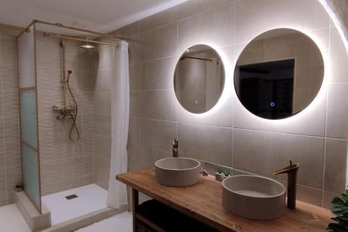 a bathroom with two sinks and a mirror and a shower at Bivouac & Sacs à dos - Loft classé, avec escape game sur demande in Sixt