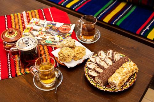 a table with food and drinks on a table at Complex Vazrozhdentsi in Tryavna