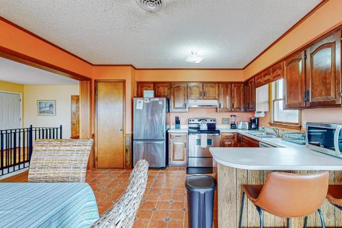 a kitchen with wooden cabinets and a table and chairs at Fenwick Island --- 20 W Maryland Avenue in Fenwick Island