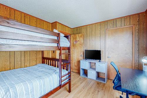 a bedroom with a bunk bed and a television at Fenwick Island --- 20 W Maryland Avenue in Fenwick Island