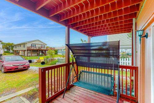 a porch of a house with a car in a yard at Fenwick Island --- 20 W Maryland Avenue in Fenwick Island